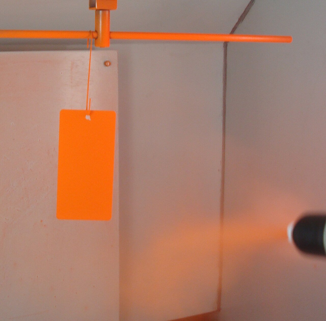 Powder-coating spray being applied to a metal frame